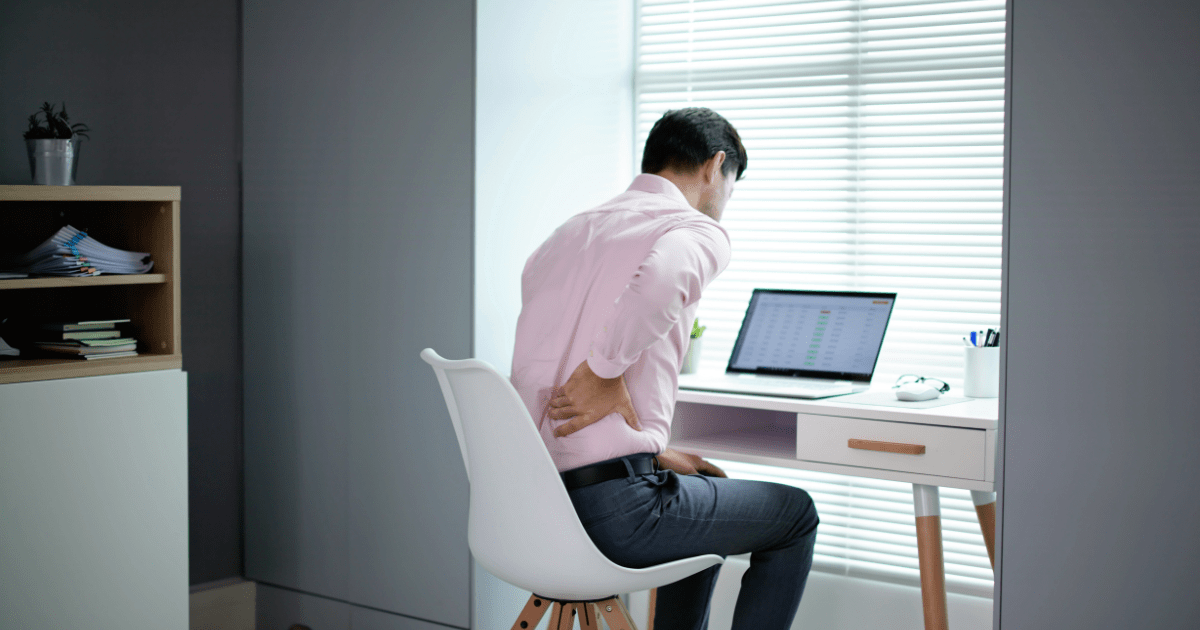 Man with Ankylosing Spondylitis sitting in wrong posture causing back pain